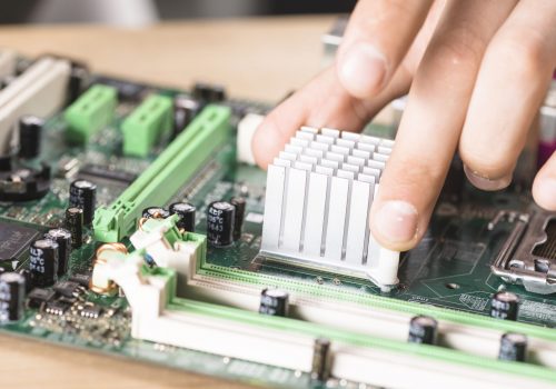 close-up-male-technician-hand-s-installing-heatsink-computer-main-board