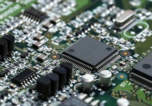 Closeup of electronic circuit board with CPU microchip electronic components background