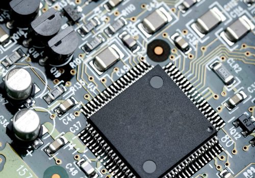 Closeup of electronic circuit board with CPU microchip electronic components background